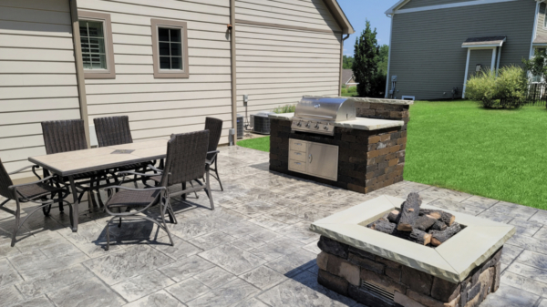 Patio with built in grill with dining area and fire pit 