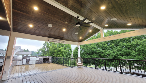 Covered composite deck with outdoor kitchen, built-in lighting, fan and outdoor heater